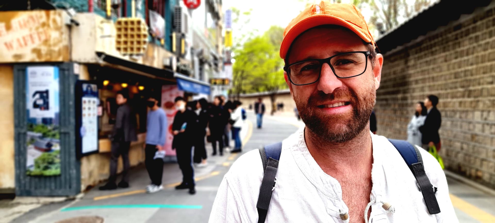 Dylan, founder of Welsh Language Hub, smiling on a city street